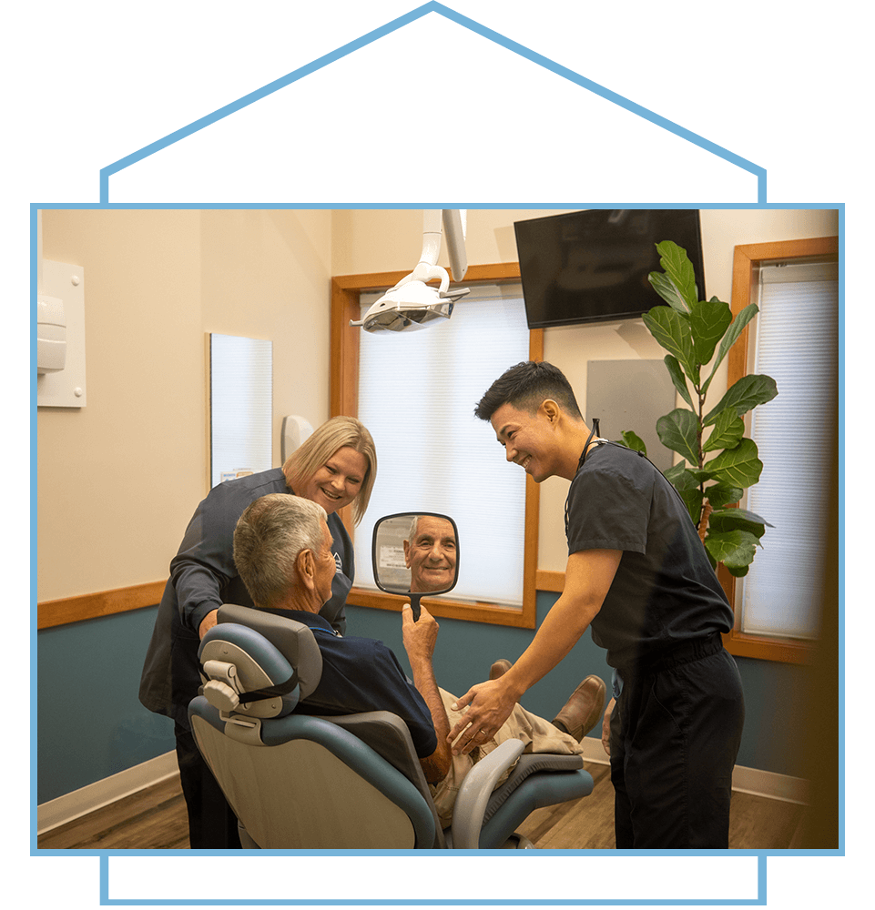 Dr.lee showing patient there teeth after dental procedure