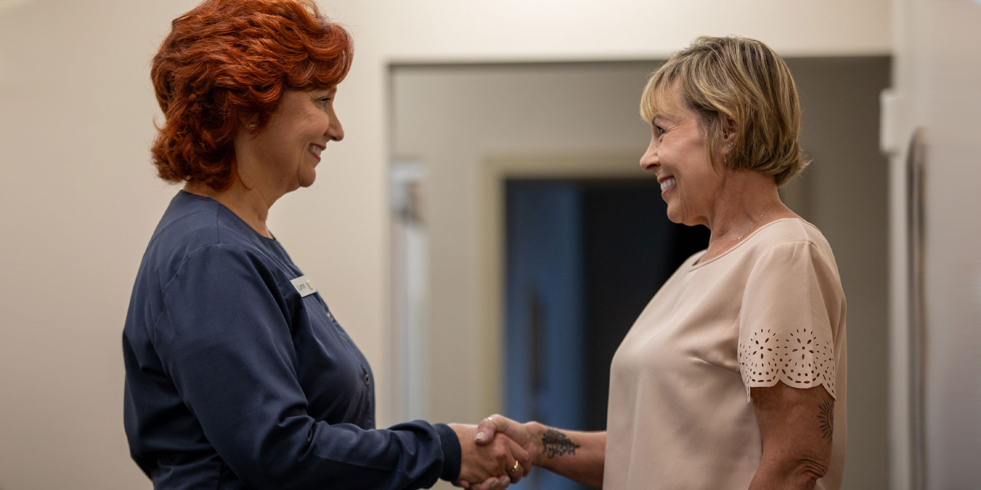 patient and team member shaking hands