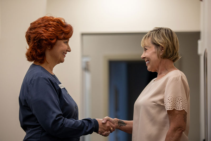 team member shaking patients hand